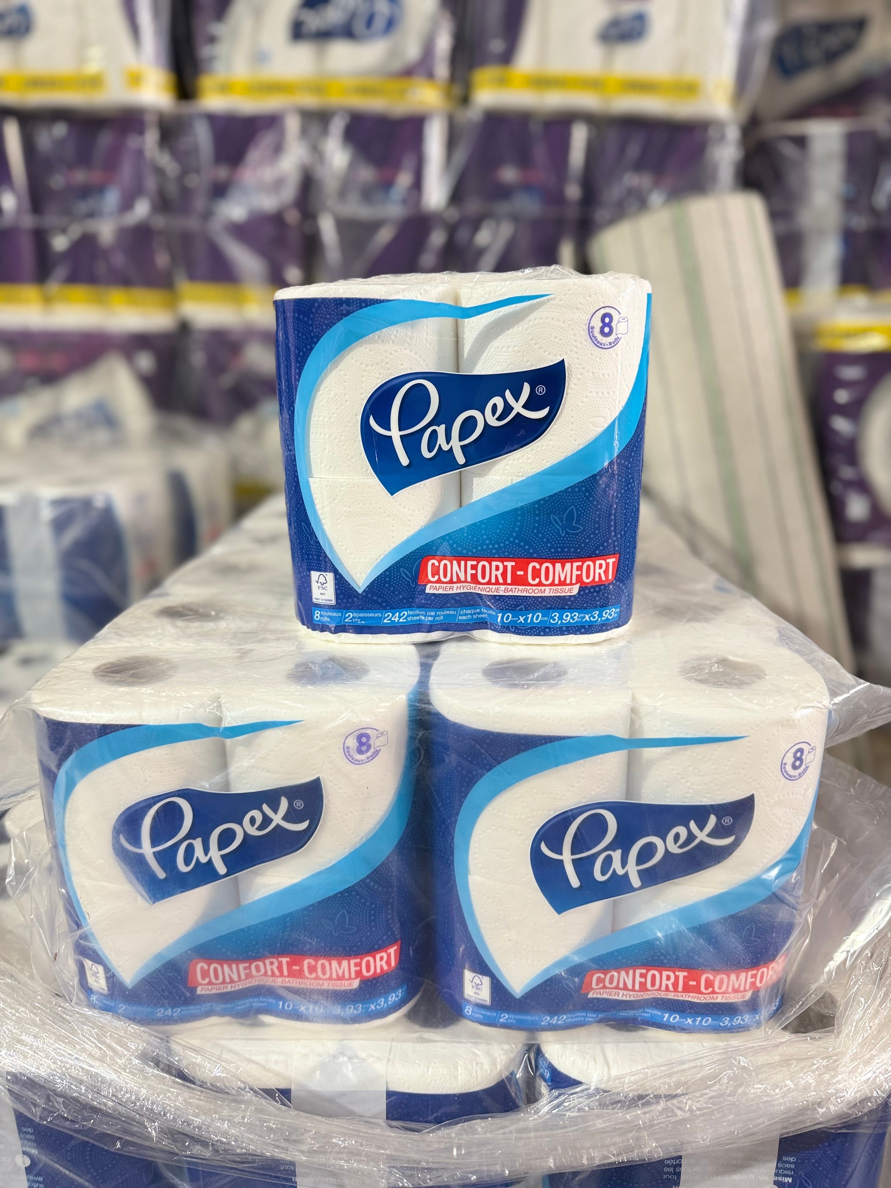 8 pack Papex toilet paper rolls stacked with a clear plastic wrap in a warehouse setting.